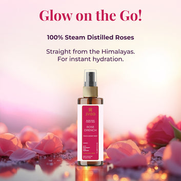 A rose water face and body mist bottle labeled 'JiViSa Rose Drench' stands among dewy rose petals on a reflective surface, set against a soft, glowing pink background. The label highlights that it contains pure Himalayan hydrosol and is plant-powered and toxin-free. Bold text above the product reads: 'Glow on the Go! 100% Steam Distilled Roses – Straight from the Himalayas. For instant hydration.' The image conveys freshness, purity, and the hydrating essence of roses through steam distillation.