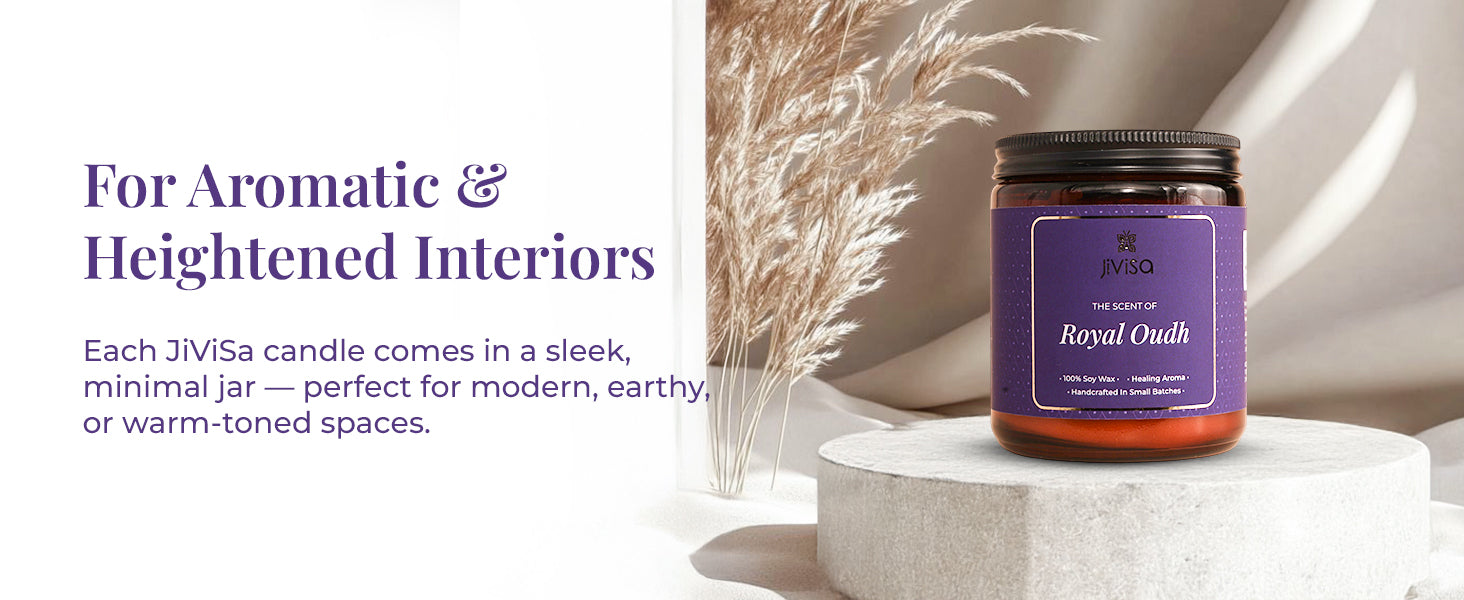 JiViSa Royal Oudh Soy Wax Candle placed on a stone pedestal with pampas grass in the background. Tagline at the top reads: “For Aromatic & Heightened Interiors.” Body text reads: “Each JiViSa candle comes in a sleek, minimal jar — perfect for modern, earthy, or warm-toned spaces.” Candle label reads: “JiViSa – The Scent of Royal Oudh – 100% Soy Wax • Healing Aroma • Handcrafted in Small Batches.”
