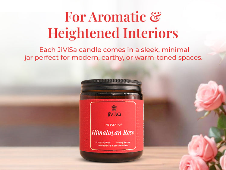 JiViSa Himalayan Rose Soy Wax Candle on a wooden table with soft-focus pink roses in the background. Tagline at the top reads: “For Aromatic & Heightened Interiors.” Body text reads: “Each JiViSa candle comes in a sleek, minimal jar perfect for modern, earthy, or warm-toned spaces.” Candle label reads: “JiViSa – The Scent of Himalayan Rose – 100% Soy Wax • Healing Aroma • Handcrafted in Small Batches.”

