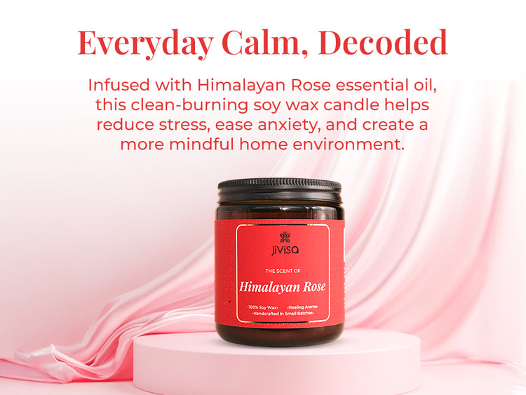 JiViSa Himalayan Rose Soy Wax Candle on a pink circular base with pink silk fabric in the background. Tagline reads: “Everyday Calm, Decoded.” Body text: “Infused with Himalayan Rose essential oil, this clean-burning soy wax candle helps reduce stress, ease anxiety, and create a more mindful home environment.” Candle label reads: “JiViSa – The Scent of Himalayan Rose – 100% Soy Wax • Healing Aroma • Handcrafted in Small Batches.”

