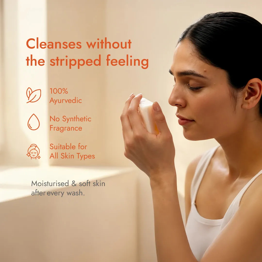 Woman smelling a JiViSa soap bar, highlighting the 100% Ayurvedic, no synthetic fragrance formula for all skin types