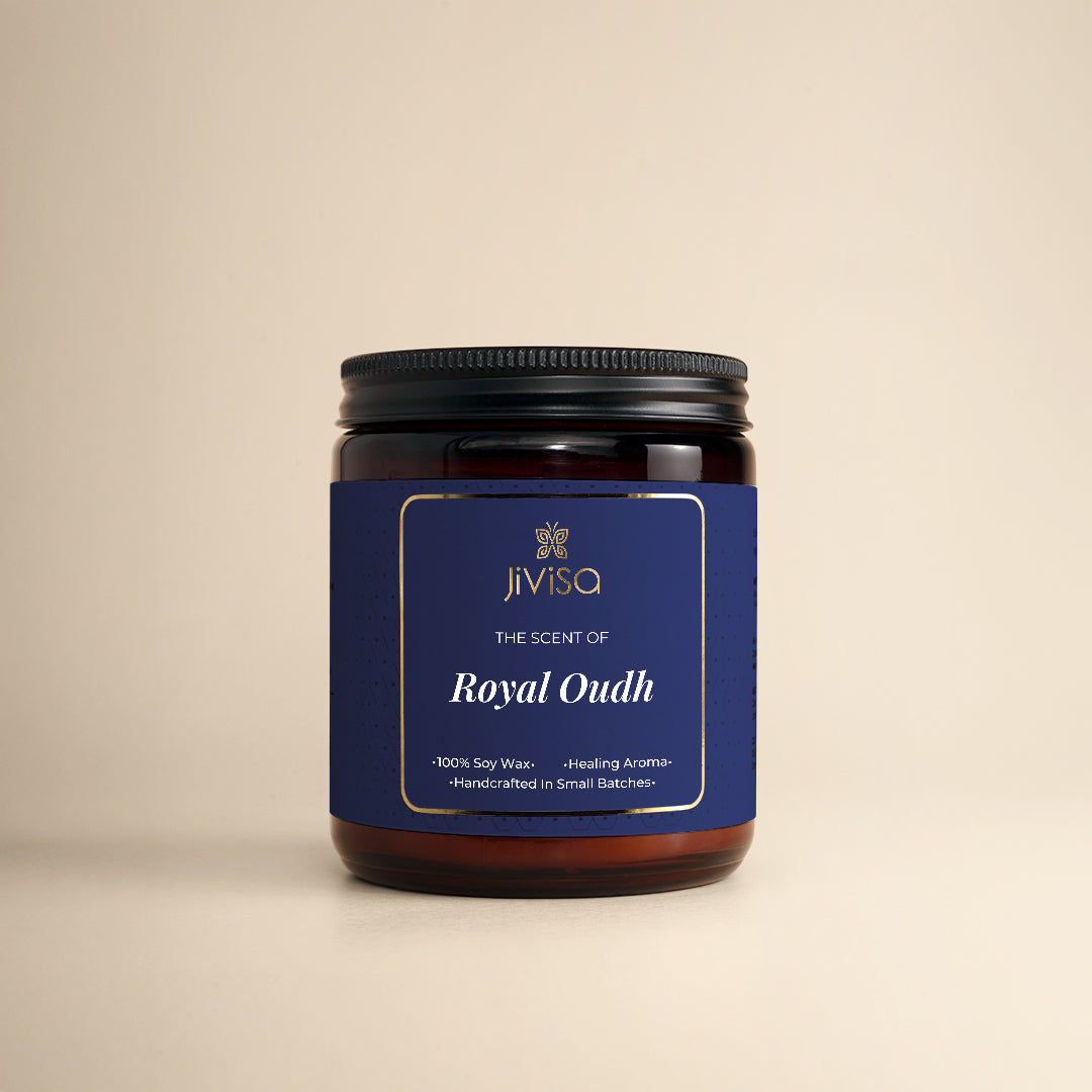 JiViSa Royal Oudh Handcrafted Soy Wax Candle 180gm in an amber glass jar with a Black tin and blue label.  The label reads: "JiViSa Wellness From The Himalayas, THE SCENT OF Royal Oudh, 100% Soy Wax Candle, Healing Aroma, Handcrafted in Small Batches".