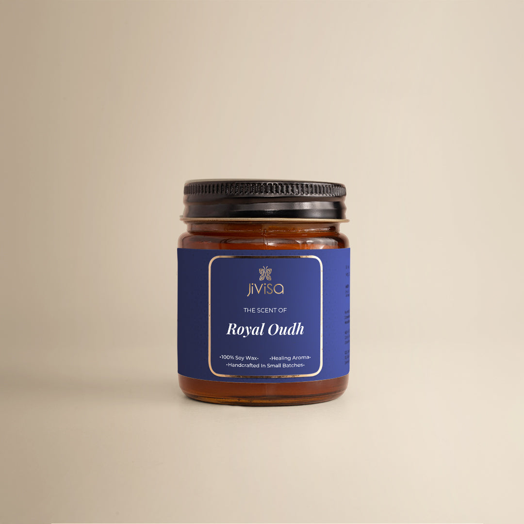 JiViSa Royal Oudh Handcrafted Soy Wax Candle 90gm in an amber glass jar with a Black tin and blue label.  The label reads: "JiViSa Wellness From The Himalayas, THE SCENT OF Royal Oudh, 100% Soy Wax Candle, Healing Aroma, Handcrafted in Small Batches".