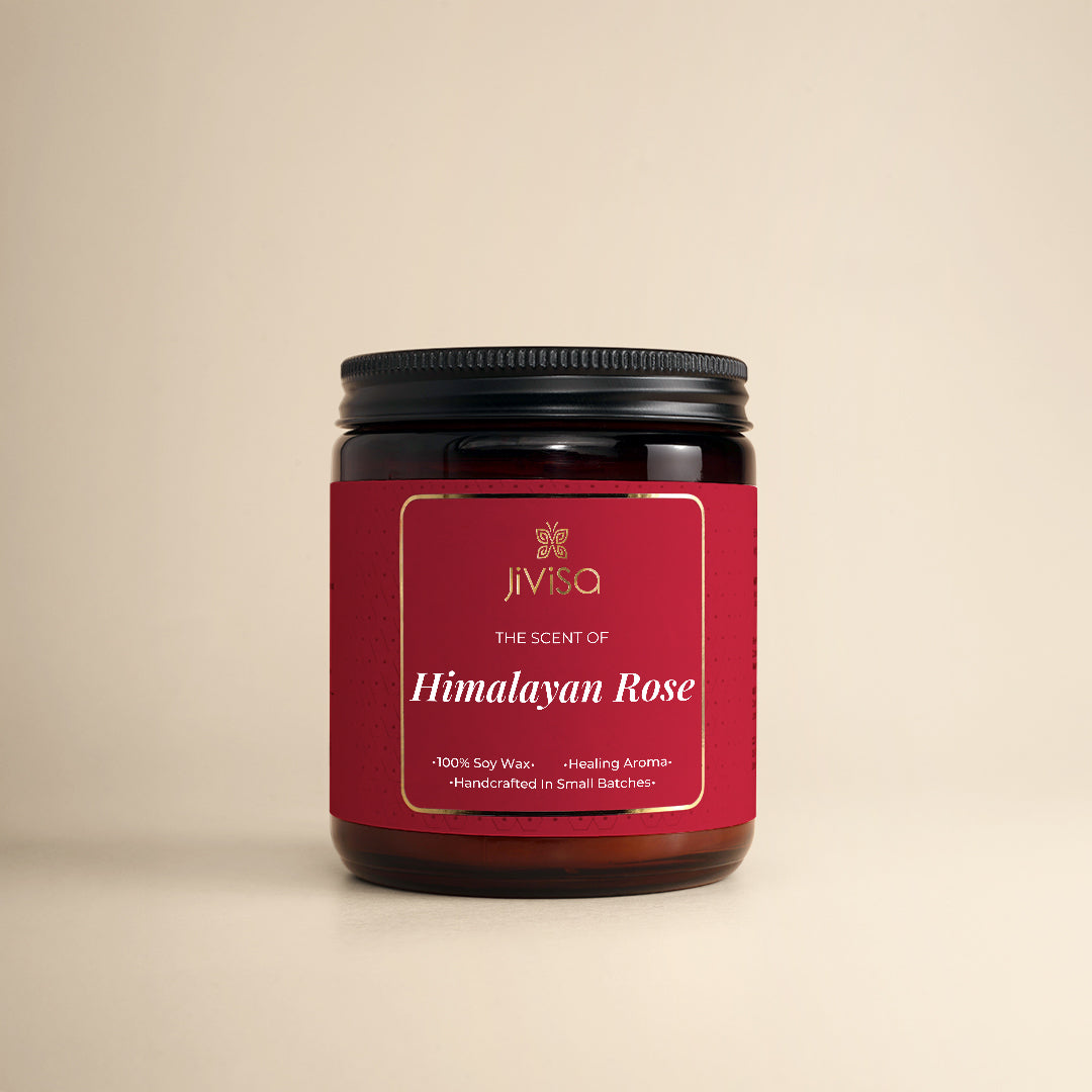 JiViSa Himalayan Lemongrass Handcrafted Soy Wax Candle 180gm in an amber glass jar with a Black tin and white label.  The label reads: &quot;JiViSa Wellness From The Himalayas, THE SCENT OF Himalayan Rose, Handcrafted 100% Soy Wax Candle, LUXURY AROMATHERAPY&quot;.