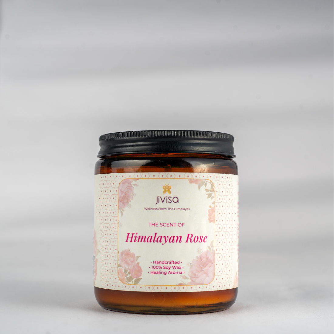 JiViSa Himalayan Lemongrass Handcrafted Soy Wax Candle 180gm in an amber glass jar with a Black tin and white label.  The label reads: &quot;JiViSa Wellness From The Himalayas, THE SCENT OF Himalayan Rose, Handcrafted 100% Soy Wax Candle, LUXURY AROMATHERAPY&quot;.
