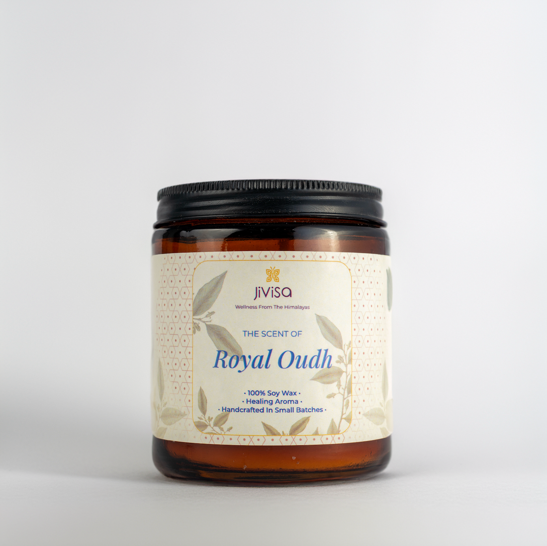 JiViSa Royal Oudh Handcrafted Soy Wax Candle 180gm in an amber glass jar with a Black tin and white label.  The label reads: &quot;JiViSa Wellness From The Himalayas, THE SCENT OF Royal Oudh, 100% Soy Wax Candle, Healing Aroma, Handcrafted in Small Batches&quot;.