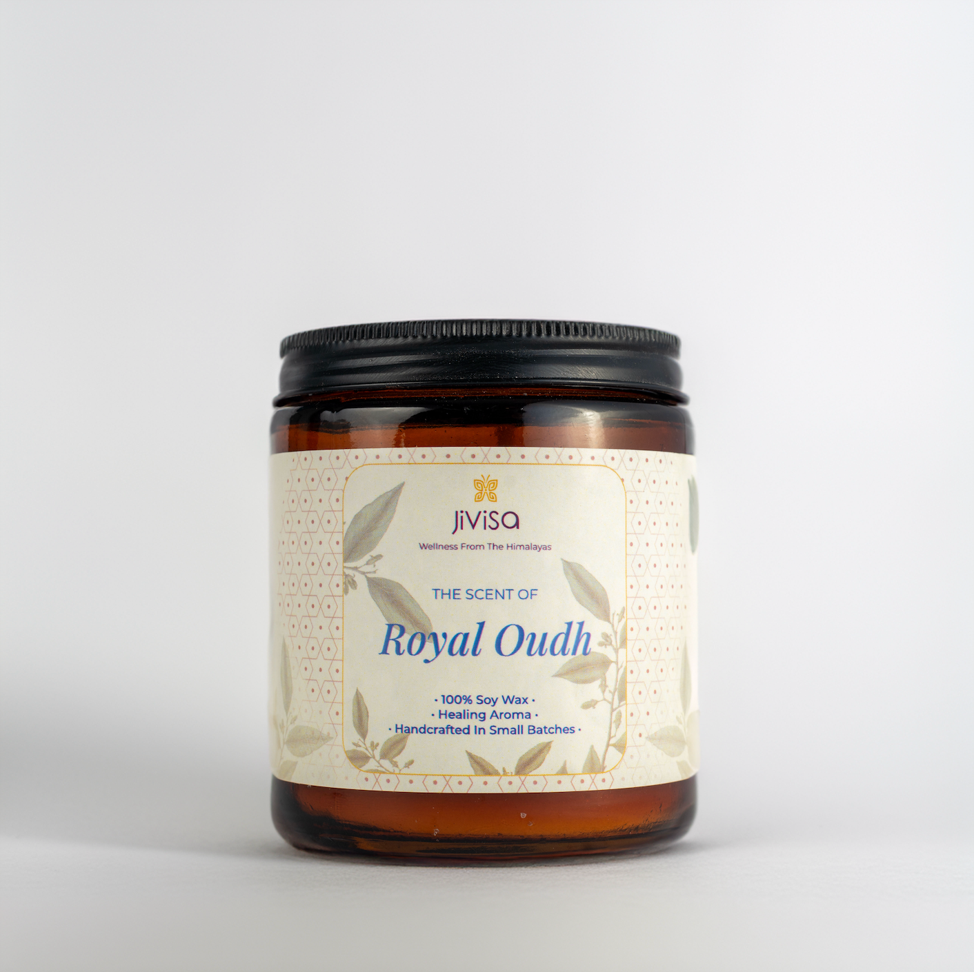 JiViSa Royal Oudh Handcrafted Soy Wax Candle 180gm in an amber glass jar with a Black tin and white label.  The label reads: &quot;JiViSa Wellness From The Himalayas, THE SCENT OF Royal Oudh, 100% Soy Wax Candle, Healing Aroma, Handcrafted in Small Batches&quot;.