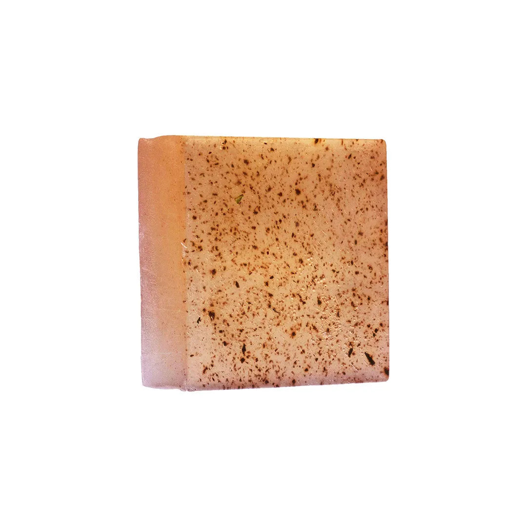 Close-up of JiViSa Seven Spice soap bar texture showing visible spice flecks