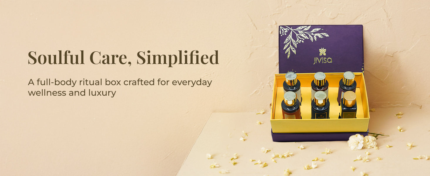 A premium, open JiViSa Soulful Self Care gift box rests on a pale cream surface with flower petals scattered around it. Inside, bestselling JiViSa's skin, hair and body essential bottles- Ananta drench face cleanser, Varta fortify hair cleanser, Badaami cold pressed oil, Tarang glaze body cleanser, Aranya glaze body milk and Varta lustre hair conditioner arranged neatly. Tagline reads "Soulful Care, Simplified," with a sub-headline that sa "A full-body ritual box crafted for everyday wellness and luxury."