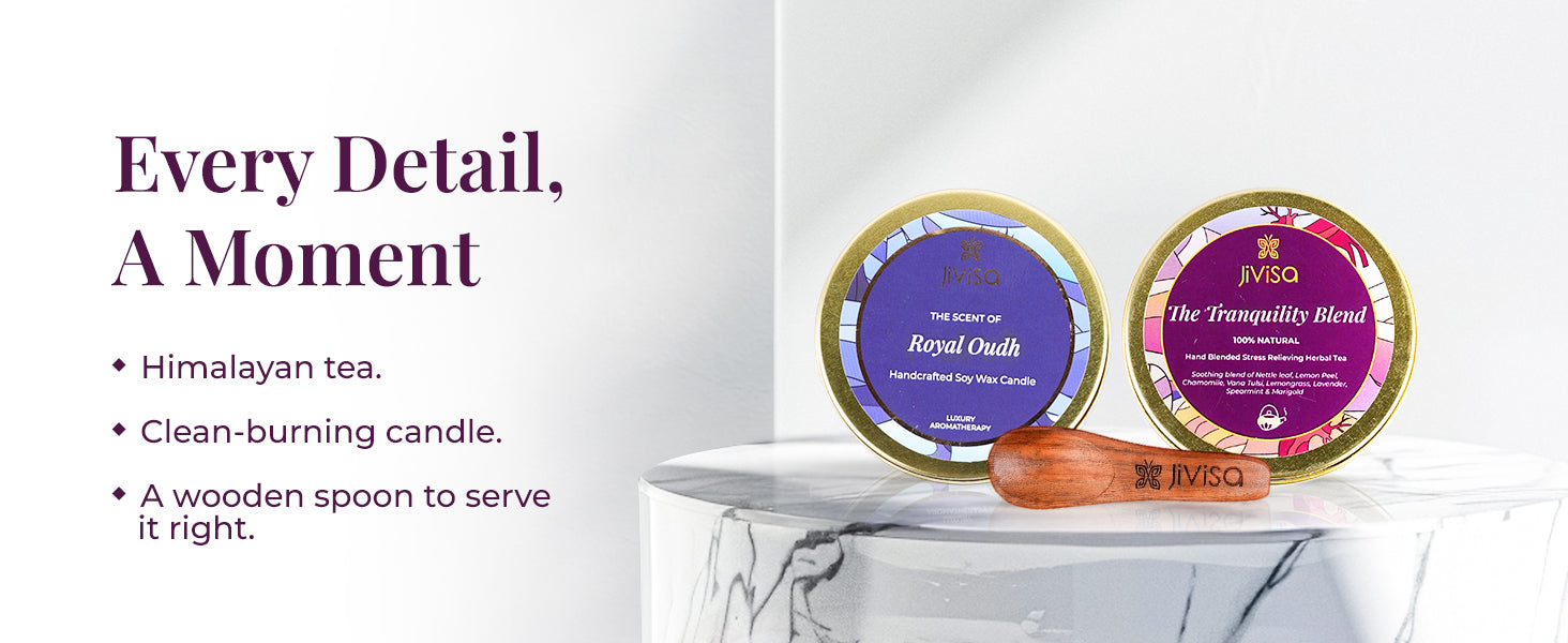 JiViSa Royal Oudh handcrafted soy wax candle and JiViSa The Tranquility Blend herbal tea tins placed side by side with a JiViSa wooden tea spoon, arranged on a white marble. Tagline on the left reads: “Every Detail, A Moment.” Bullet points list: Himalayan tea | Clean-burning candle | A wooden spoon to serve it right.