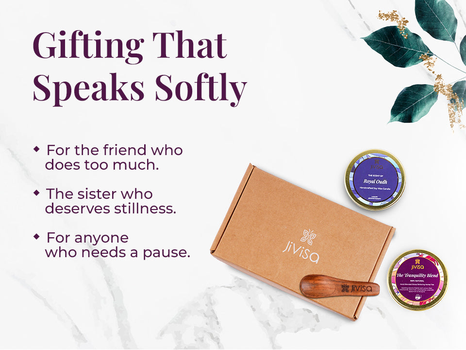Flat lay of JiViSa Tranquil Himalayan Gift Box with affirmation card, JiViSa Royal Oudh candle tin, JiViSa  Tranquility herbal tea Blend tin, and JiViSa  wooden spoon. Tagline the left reads: “Gifting That Speaks Softly” with bullet points: For the friend who does too much | The sister who deserves stillness | For anyone who needs a pause.