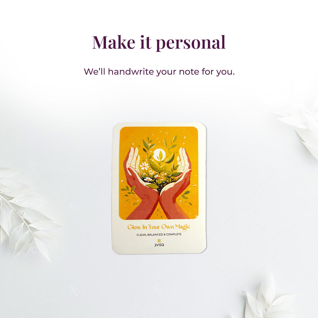 &quot;Make it personal – We’ll handwrite your message for you.&quot; A handwritten card with warm yellow and orange tones shows two hands holding blooming herbs with a glowing sun. Placed on a white surface, the image emphasizes the personal, heartfelt gifting experience JiViSa offers.