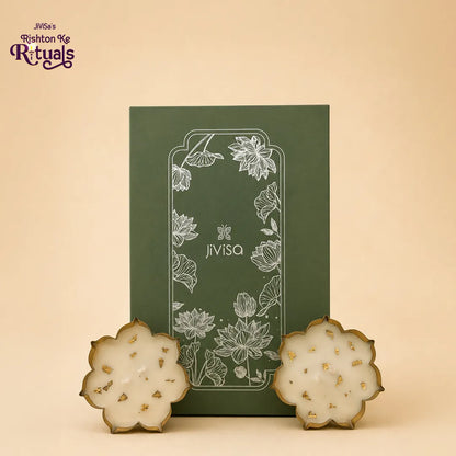 JiViSa Urli Elegance Aroma Box with two lotus urli candles in gold-rimmed bowls beside the sage green lotus gift box.