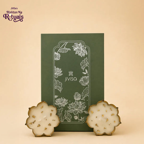 JiViSa Urli Elegance Aroma Box with two lotus urli candles in gold-rimmed bowls beside the sage green lotus gift box.