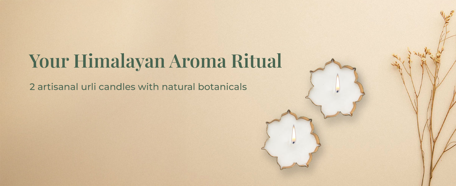  A close-up shot of two litJiViSa  urli candles on a light beige background with dried plant stems on the right. The tagline on the left says, "Your Himalayan Aroma Ritual" and below that, supporting text reads "2 artisanal urli candles with natural botanicals".