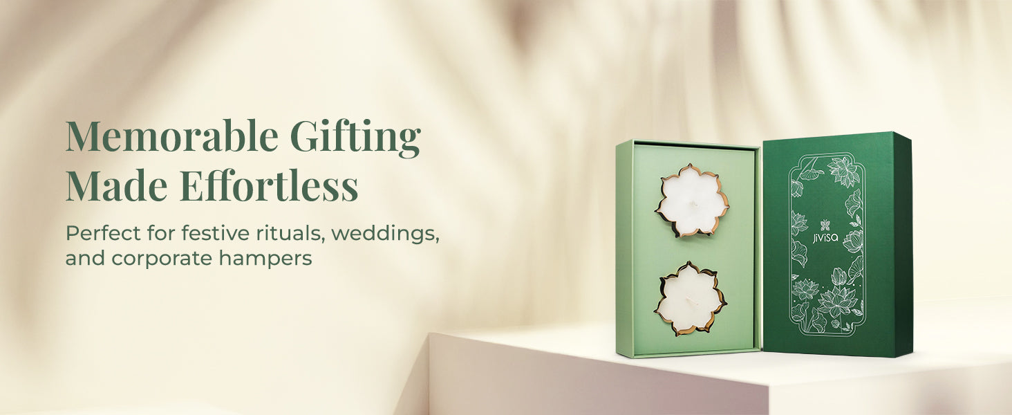An open JiViSa Urli Elegance Aroma gift box displayed on a light-colored surface with a beige background. The green box contains two handcrafted JiViSa urli candles. On the left, the tagline reads "Memorable Gifting Made Effortless" with a supporting text "Perfect for festive rituals, weddings, and corporate hampers."