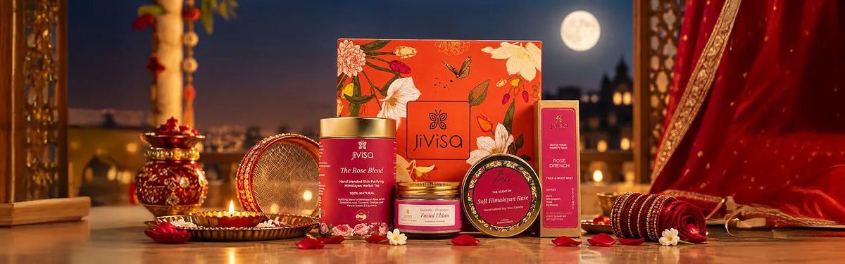 JiViSa Karwa Chauth gift set with Rose Blend tea, Facial Ubtan, Himalayan Rose candle, and Rose Drench mist, styled against a full moon and festive courtyard.