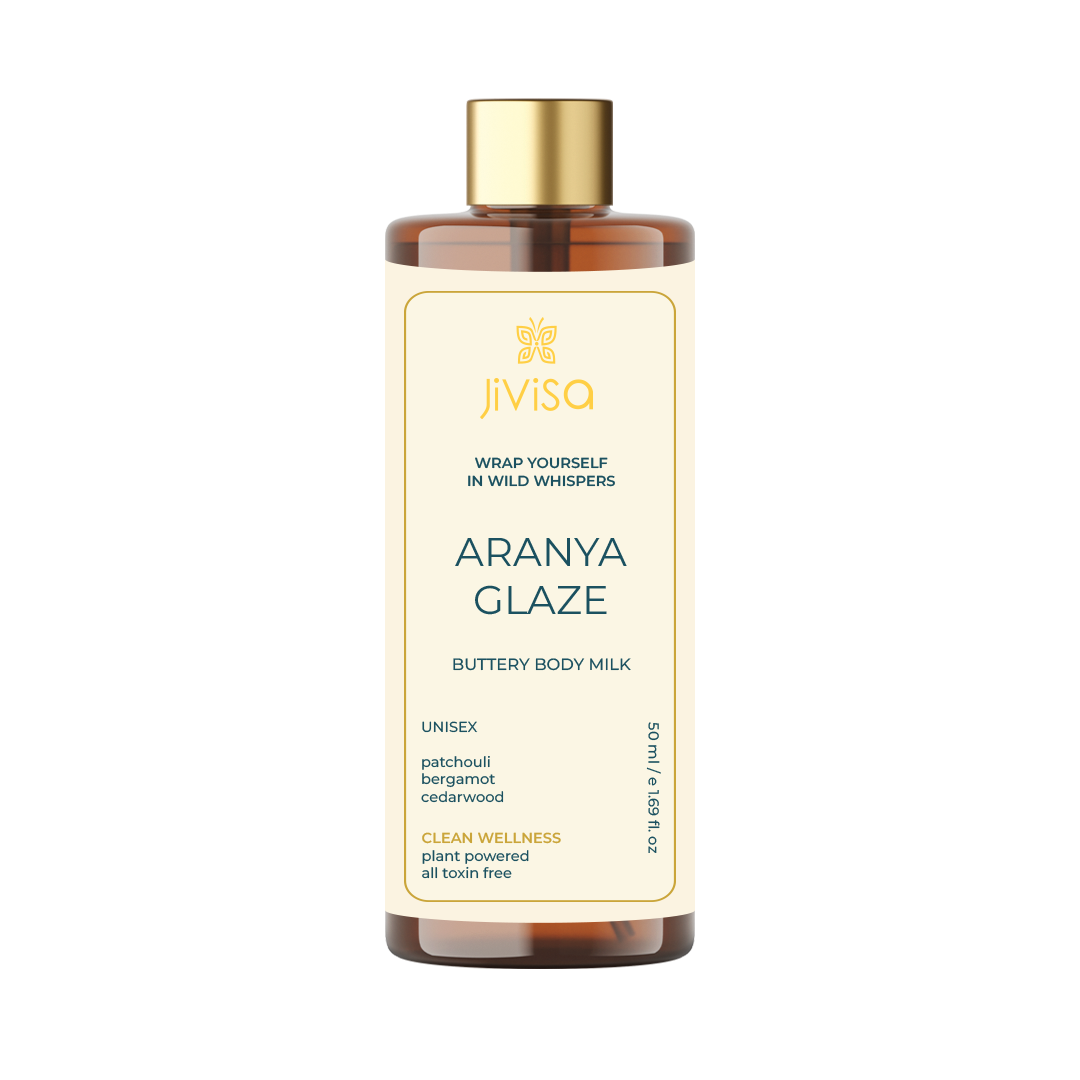 Front view of JiViSa Aranya Glaze Buttery Body Milk bottle with product name, key ingredients like patchouli, bergamot, cedarwood, and descriptions highlighting clean wellness and toxin-free formulation.